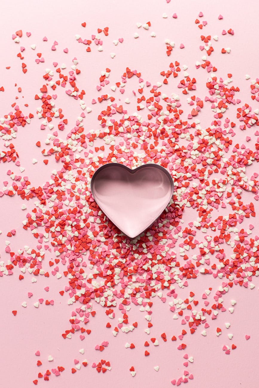 paper confetti in heart shape on pink table